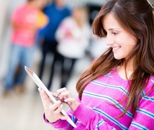 Mother reading a prompt reply on her phone to a childcare centre inquiry