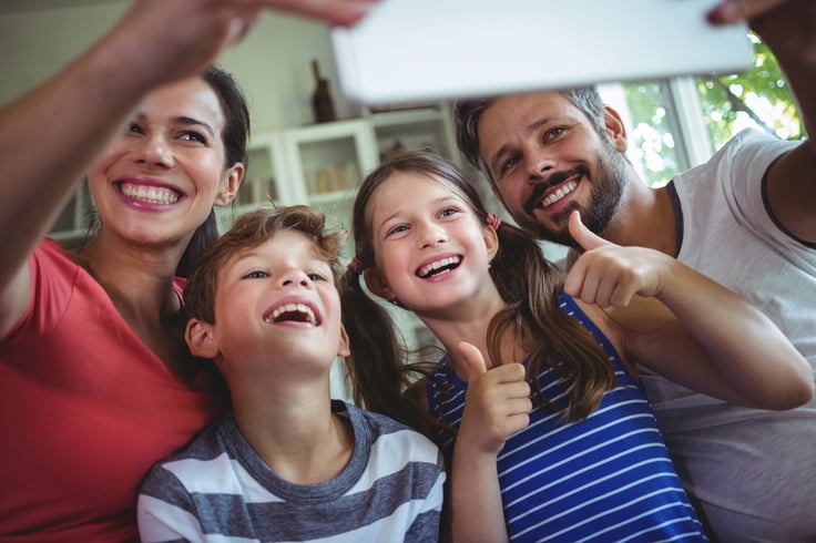 Happy family at taking a selfie at home with digital tablet