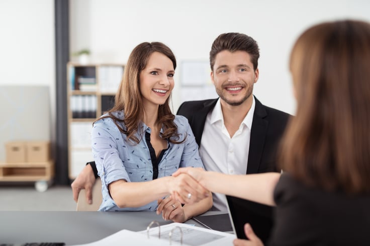 Happy Young Professional Couple Shaking Hands with a childcare educator