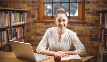 teacher with books and laptop