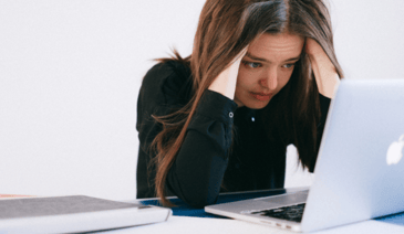woman with headache at computer