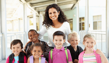 female teacher posing with group of young students: national teacher appreciation week