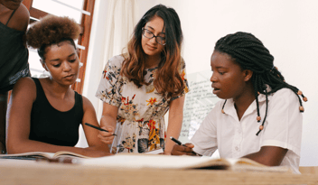 three childcare business staff looking at enrollment retention reports