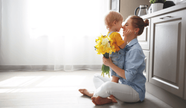childcare provider sitting with young child