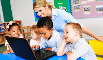 teacher on laptop: better childcare management with technology 