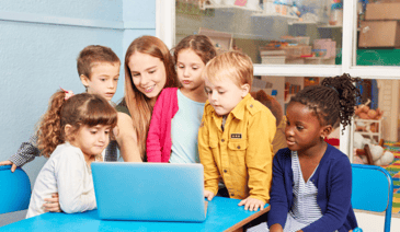 kids and teacher around a laptop