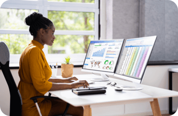 Woman looking at computer searching the top childcare trends of 2025